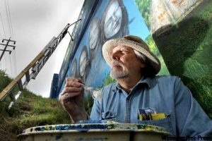 Tom Andrich painting mural, Winnipeg overpass