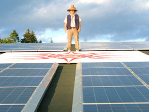 Chief Standing on Solar roof. Photo by Andrew Moore.